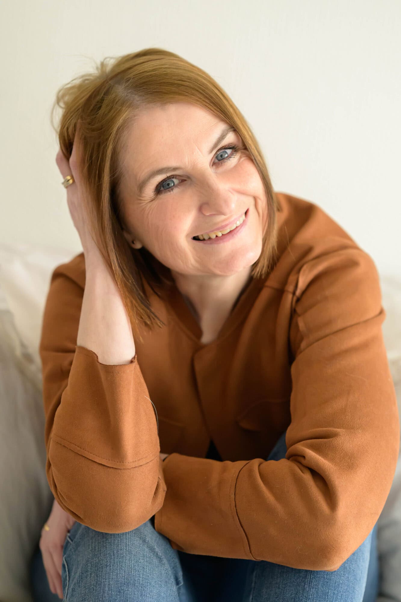 Photo de Virginie Petitjean, souriante, avec une main dans les cheveux